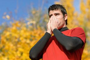 16467692 - young athlete coughing and blowing with a tissue. caucasian hispanic male model.